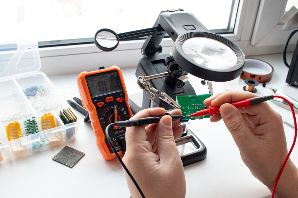 A person using a multimeter to test a circuit.
